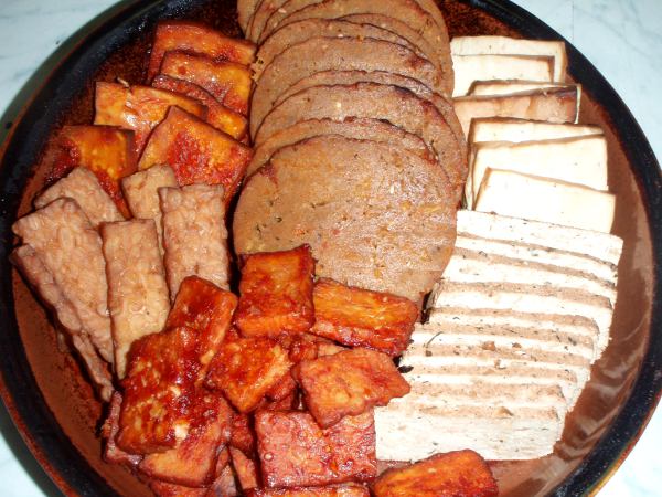 Lajitelma kuutta eri sorttia seitania, tofua ja tempeä. Oikealla ylhäällä savustettua Tofu Moon -merkkistä tofua, oik. alhaalla mantelitofua, ylh. keskellä seitankinkkua, alh. keskellä marinoitua tempeä, vas. ylh. marinoitua tofua  ja vas. alh. savustettua tempeä. 