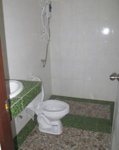 Vastarakennetun talon uusi kylpyhuone, jossa vedet jää suihkun lattialle. 