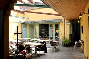 Komkommertijdin sisäpiha, sen takana oli asiallisen näköinen ravintolasali. 