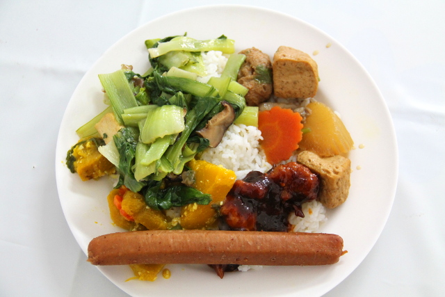 Ruoka-annos Hesan Vegetarianista Phuket Townissa. Osoittelen tiskin ruokia ja sitä mukaa myyjä kasaa niitä riisin päälle. Vähäruokaiset thaimaalaiset ottavat yleensä maksimissaan kolmea lajia, joten neljän-viiden lajin ottaminen hämmentää aina myyjiä. Tämä annos maksoi varmaan jotain 70 bahtia.